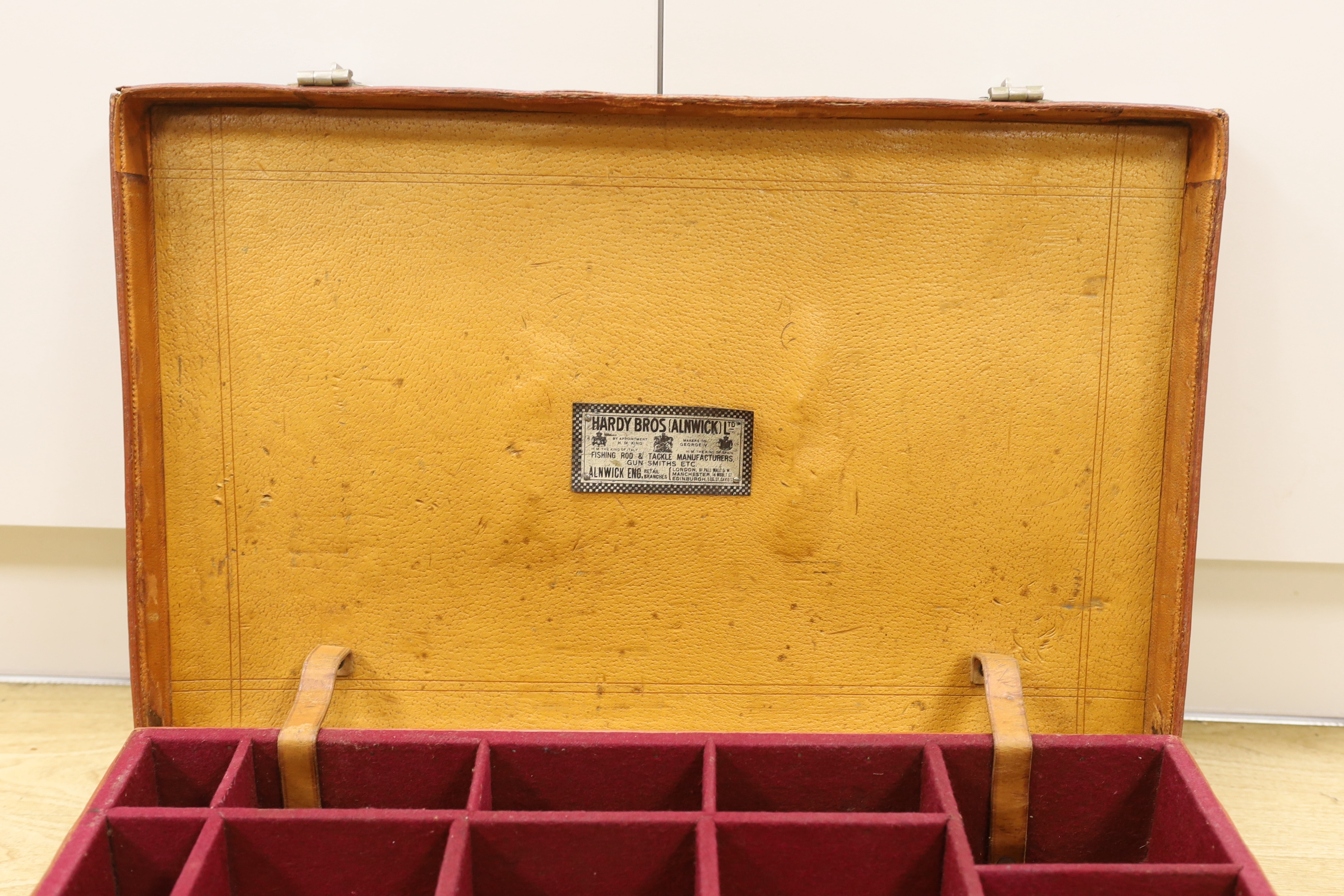 An early 20th century Hardy Bros. Alnwick tan leather fishing reel case, 58cm max.